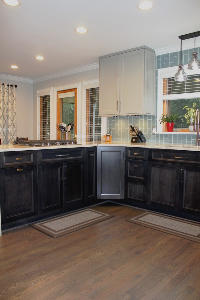 Inspiration for a large transitional u-shaped medium tone wood floor and brown floor eat-in kitchen remodel in Detroit with an undermount sink, recessed-panel cabinets, gray cabinets, quartzite countertops, blue backsplash, glass tile backsplash, stainless steel appliances, a peninsula and multicolored countertops