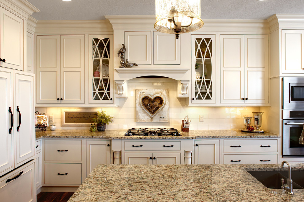 Inspiration for a timeless kitchen remodel in Miami with an undermount sink, beaded inset cabinets, beige cabinets, beige backsplash, subway tile backsplash and stainless steel appliances