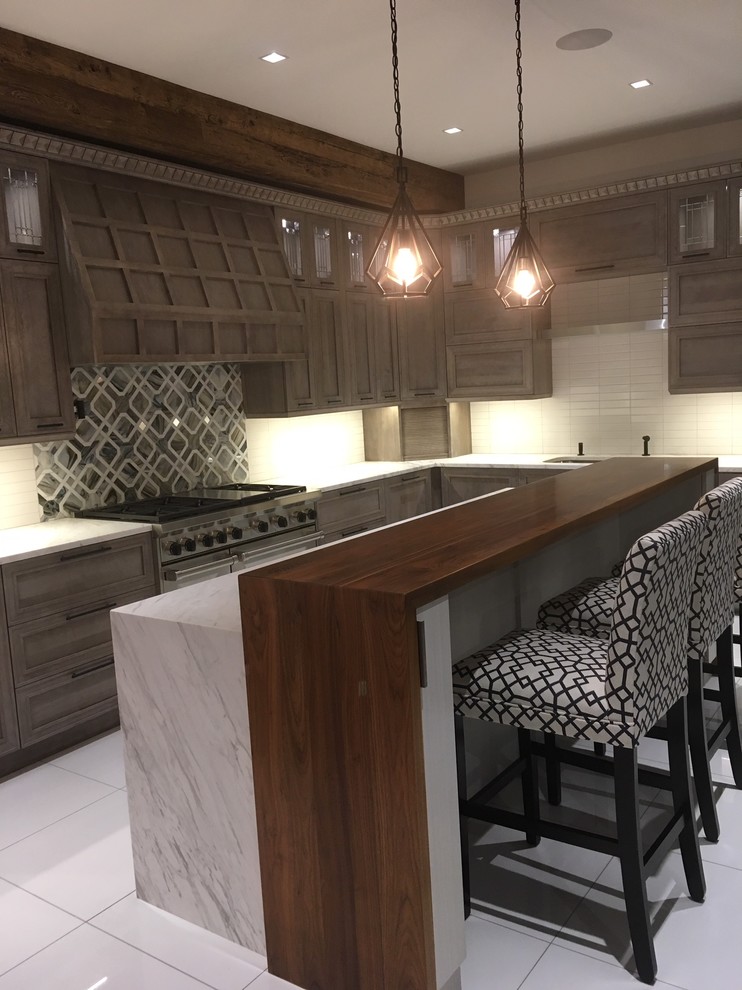 Photo of an expansive modern l-shaped kitchen/diner in Bridgeport with a single-bowl sink, flat-panel cabinets, grey cabinets, marble worktops, white splashback, ceramic splashback, stainless steel appliances, porcelain flooring, an island, white floors and white worktops.