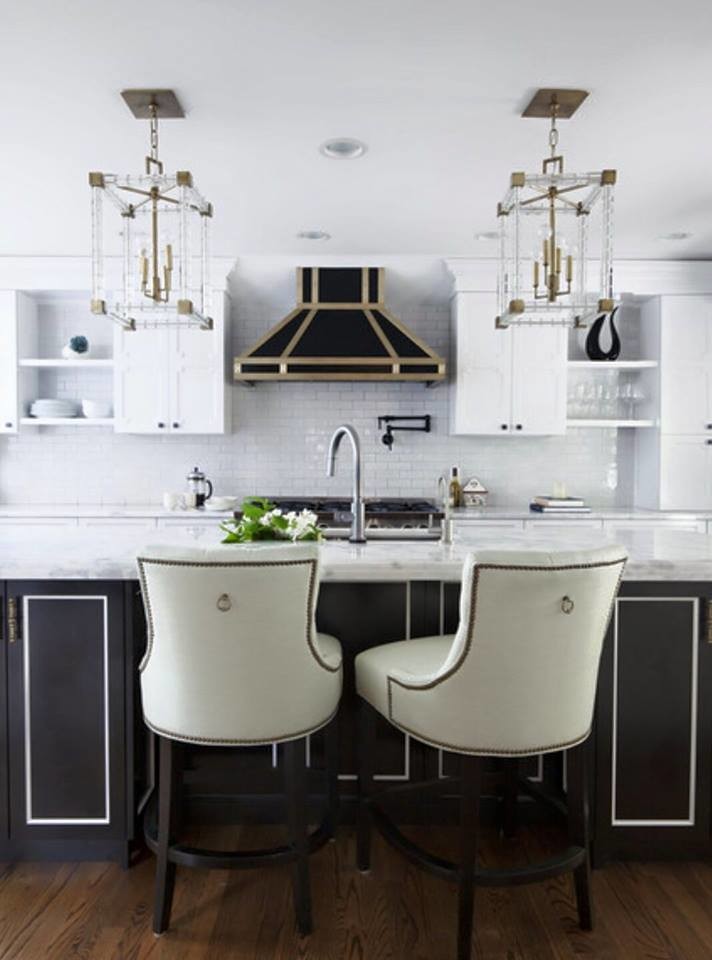 Photo of a medium sized contemporary kitchen/diner in Los Angeles with a submerged sink, recessed-panel cabinets, grey cabinets, marble worktops, white splashback, ceramic splashback, black appliances, medium hardwood flooring and an island.
