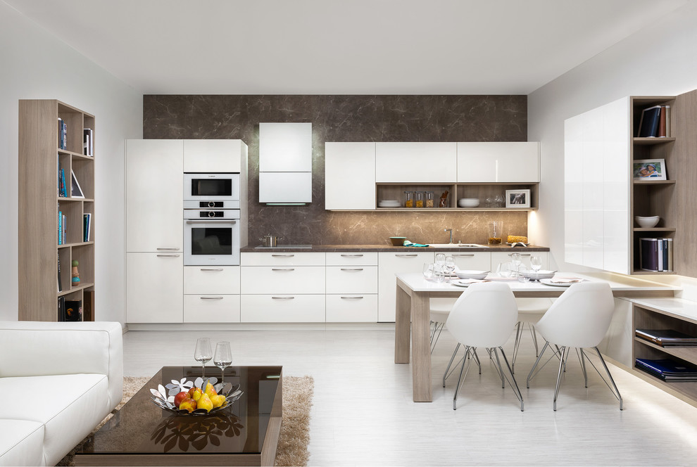 Medium sized modern single-wall kitchen/diner in Other with lino flooring, an integrated sink, flat-panel cabinets, white cabinets, laminate countertops, brown splashback, white appliances and no island.