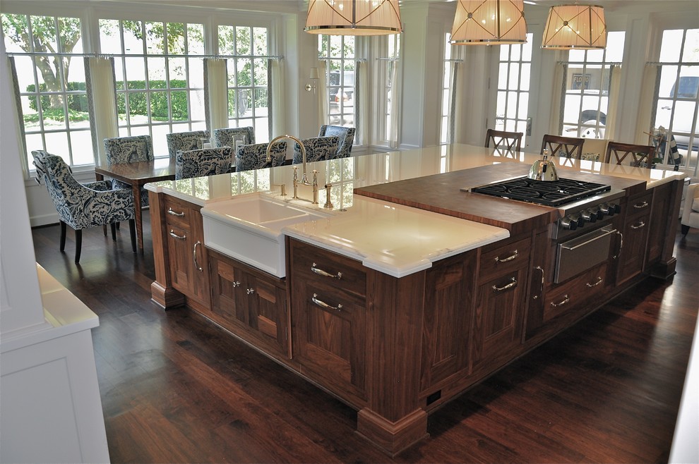 Inspiration for a large timeless l-shaped dark wood floor eat-in kitchen remodel in Dallas with a farmhouse sink, shaker cabinets, white cabinets, marble countertops, stainless steel appliances and an island