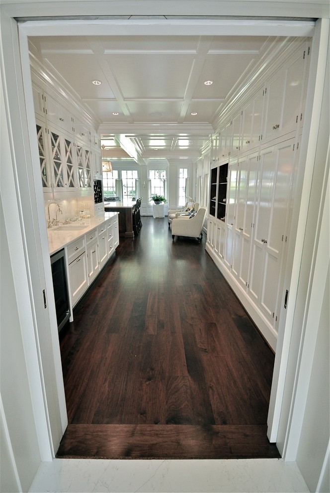 Eat-in kitchen - large traditional l-shaped dark wood floor eat-in kitchen idea in Dallas with shaker cabinets, white cabinets, marble countertops, stainless steel appliances, an island and an undermount sink