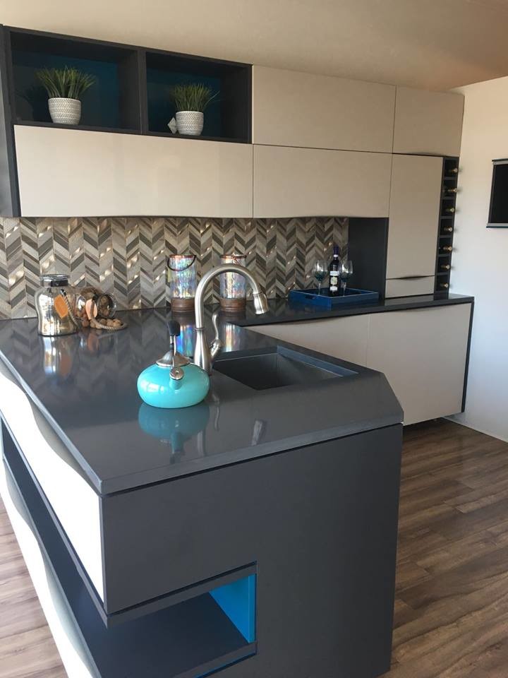 Example of a small minimalist l-shaped dark wood floor and brown floor eat-in kitchen design in Orlando with raised-panel cabinets, beige cabinets, quartzite countertops, multicolored backsplash, mosaic tile backsplash and green countertops