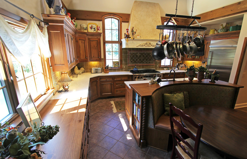 Klassisk inredning av ett stort kök, med en undermonterad diskho, rostfria vitvaror och en köksö