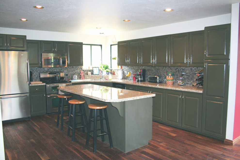 Photo of a medium sized traditional u-shaped kitchen/diner in Salt Lake City with raised-panel cabinets, green cabinets, granite worktops, slate splashback, an island, dark hardwood flooring, a submerged sink and stainless steel appliances.