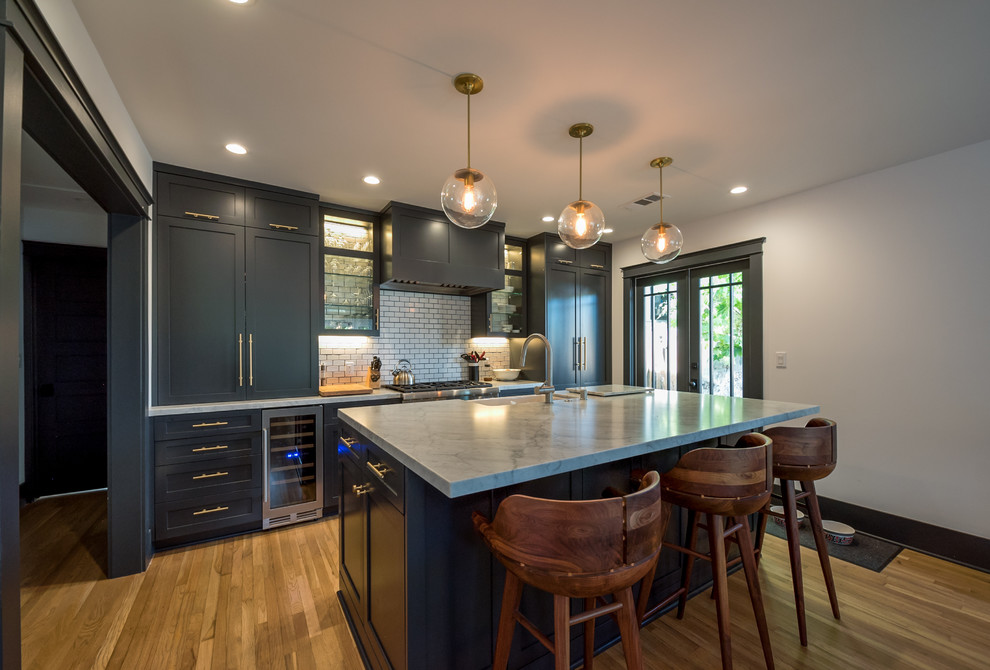 Mid-sized arts and crafts single-wall eat-in kitchen photo in Los Angeles with shaker cabinets, blue cabinets, marble countertops, white backsplash, porcelain backsplash, colored appliances and an island