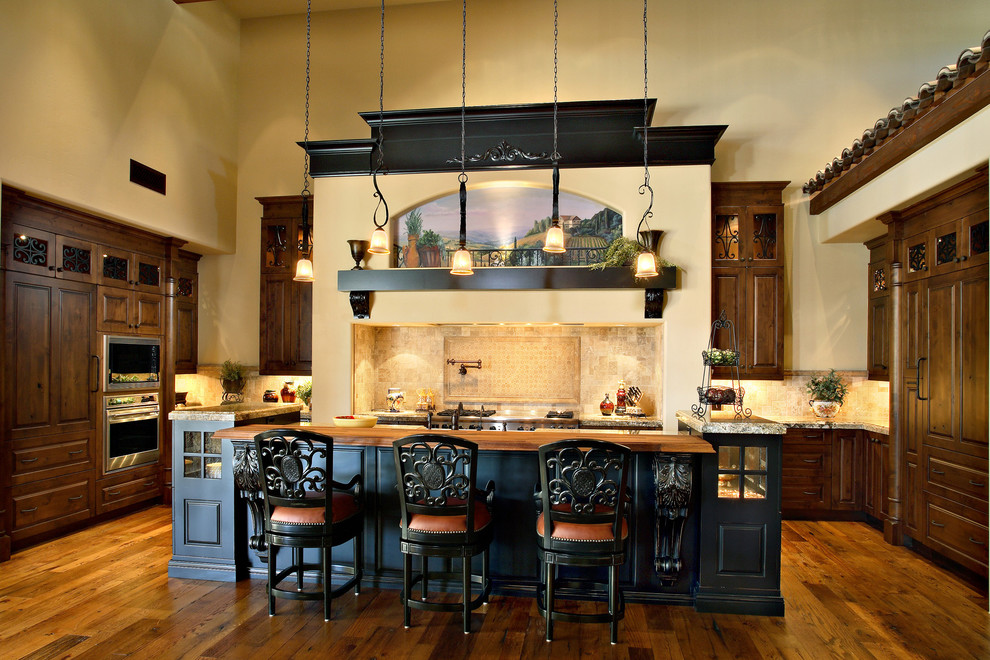 Tuscan kitchen photo in Phoenix with raised-panel cabinets