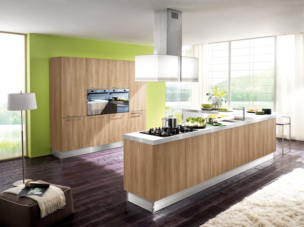 Eat-in kitchen - mid-sized modern l-shaped medium tone wood floor eat-in kitchen idea in San Diego with a double-bowl sink, flat-panel cabinets, medium tone wood cabinets, marble countertops, yellow backsplash, ceramic backsplash, paneled appliances and a peninsula