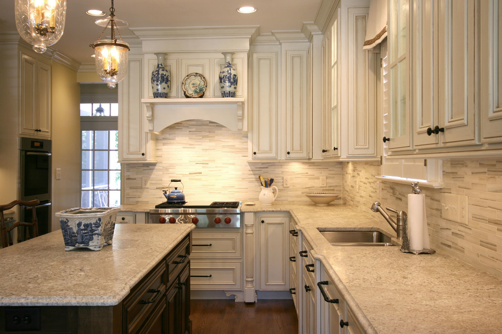 Elegant eat-in kitchen photo in Charlotte with an undermount sink, flat-panel cabinets, white cabinets, white backsplash and matchstick tile backsplash