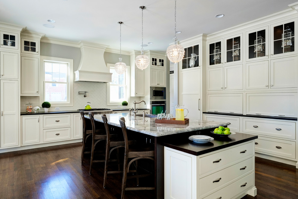 Large transitional l-shaped dark wood floor eat-in kitchen photo in Chicago with an undermount sink, beaded inset cabinets, white cabinets, granite countertops, white backsplash and paneled appliances