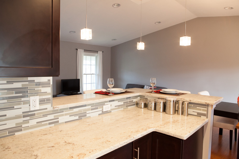 Example of a small trendy u-shaped light wood floor eat-in kitchen design in Chicago with shaker cabinets, granite countertops, glass tile backsplash, stainless steel appliances, an undermount sink, dark wood cabinets, gray backsplash and no island