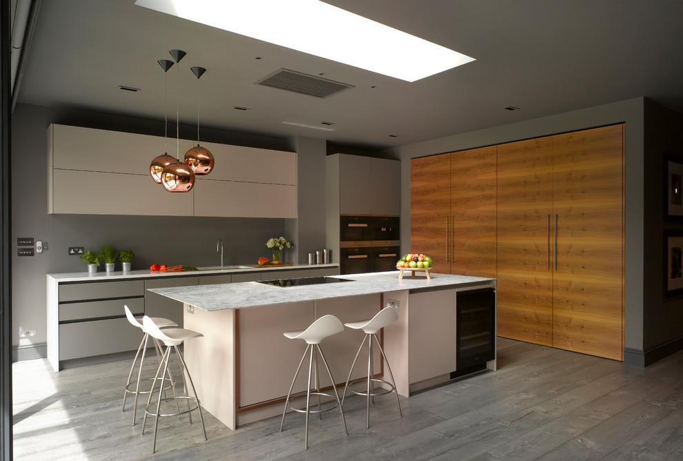 Foto på ett stort funkis vit linjärt kök med öppen planlösning, med släta luckor, vita skåp, bänkskiva i kvartsit, vitt stänkskydd, glaspanel som stänkskydd, målat trägolv, en köksö och grått golv