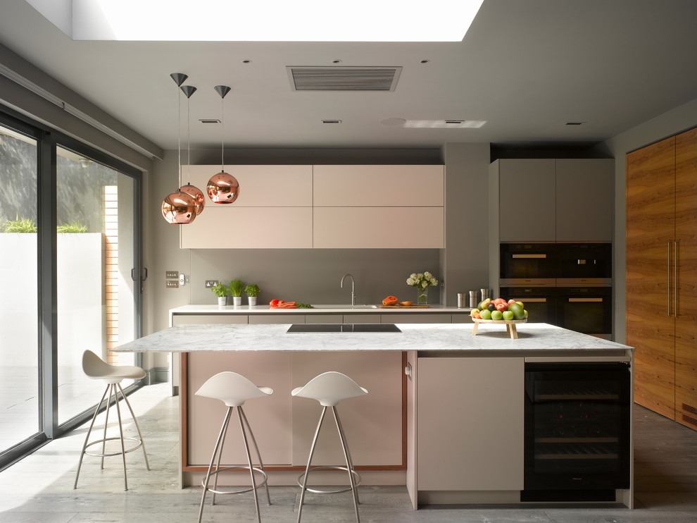 Inspiration for a large contemporary single-wall open plan kitchen in London with flat-panel cabinets, white cabinets, quartz worktops, white splashback, glass sheet splashback, painted wood flooring, an island, grey floors and white worktops.