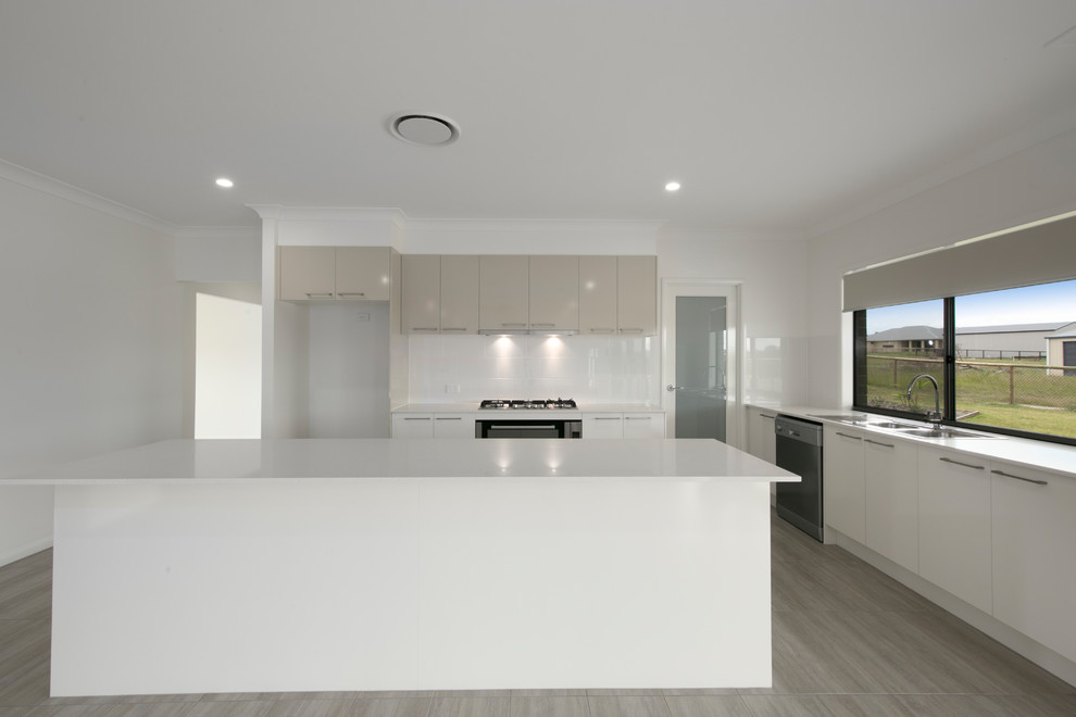 Design ideas for a large modern galley open plan kitchen in Brisbane with a double-bowl sink, beige cabinets, engineered stone countertops, window splashback, stainless steel appliances, ceramic flooring, an island and brown floors.