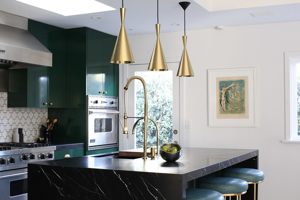 This is an example of a contemporary kitchen in Los Angeles with flat-panel cabinets, green cabinets, white splashback, stainless steel appliances and an island.
