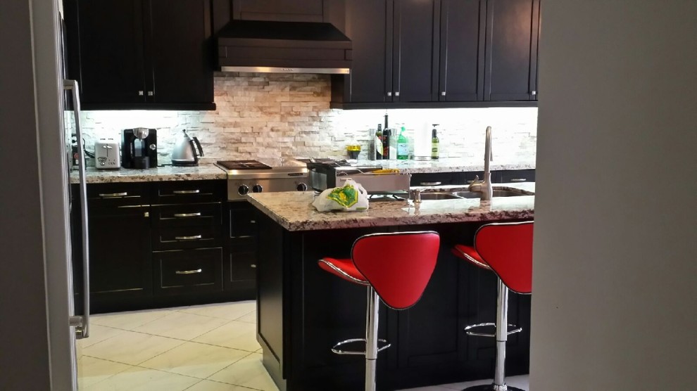 Example of a mid-sized classic galley ceramic tile and beige floor enclosed kitchen design in Toronto with a double-bowl sink, recessed-panel cabinets, dark wood cabinets, marble countertops, beige backsplash, slate backsplash, stainless steel appliances, an island and multicolored countertops