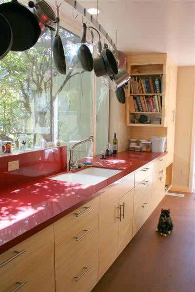 Inspiration for a large modern galley kitchen pantry in San Francisco with a double-bowl sink, flat-panel cabinets, light wood cabinets, engineered stone countertops, red splashback, stone tiled splashback, white appliances and no island.