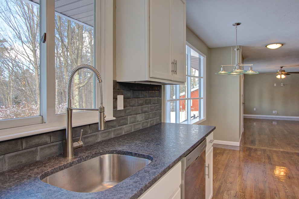 Photo of a modern kitchen in Boston with cement tile splashback.