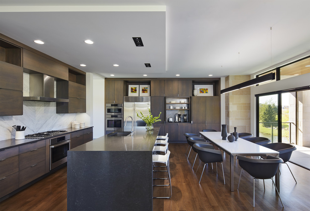 Design ideas for a modern kitchen/diner in Minneapolis with a submerged sink, flat-panel cabinets, dark wood cabinets, grey splashback, stainless steel appliances, dark hardwood flooring, an island and brown floors.