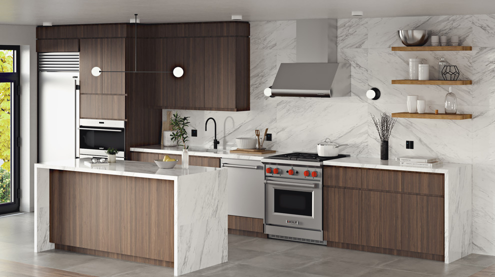 Photo of a contemporary single-wall kitchen/diner in New York with a submerged sink, flat-panel cabinets, medium wood cabinets, marble worktops, white splashback, marble splashback, stainless steel appliances, porcelain flooring, an island, grey floors and white worktops.