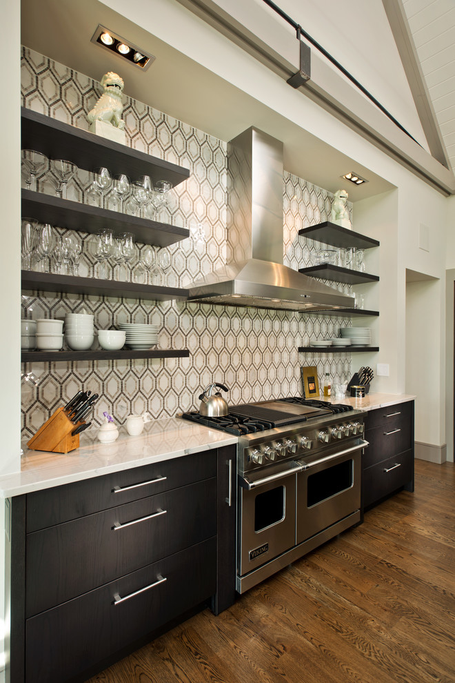 Contemporary kitchen in Boston with marble worktops, white splashback, cement tile splashback, stainless steel appliances, dark hardwood flooring and an island.