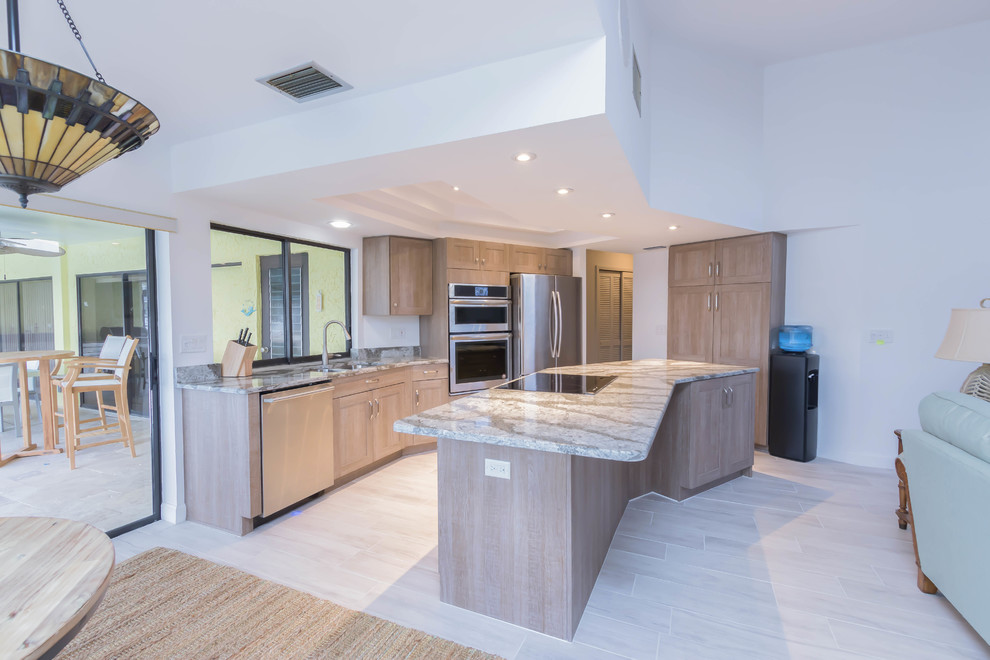Inspiration for a medium sized contemporary l-shaped open plan kitchen in Other with a submerged sink, shaker cabinets, medium wood cabinets, engineered stone countertops, grey splashback, stone slab splashback, stainless steel appliances, porcelain flooring, an island and brown floors.