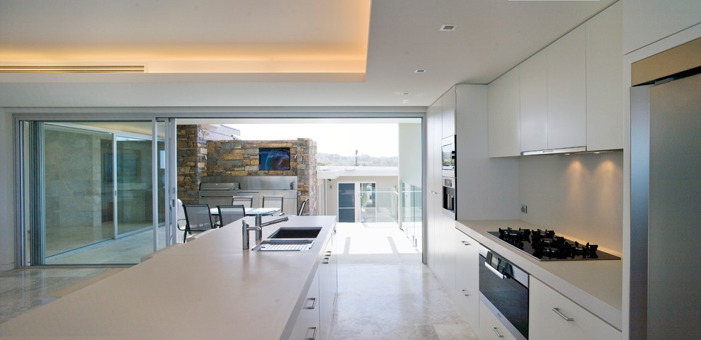 This is an example of a modern kitchen in Sydney with flat-panel cabinets.