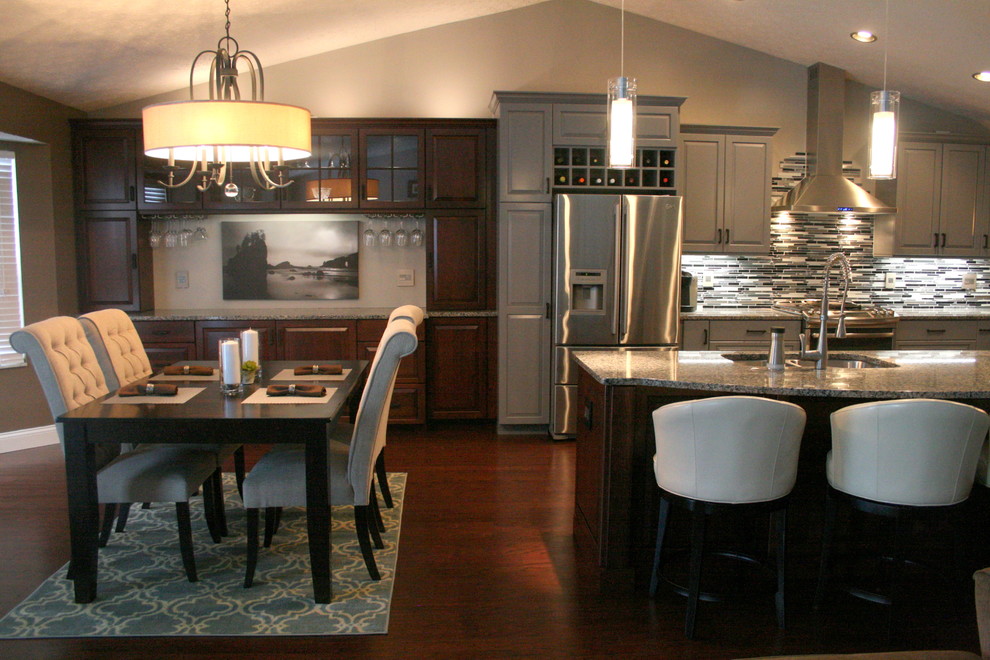 Modern inredning av ett mellanstort kök, med en undermonterad diskho, luckor med upphöjd panel, grå skåp, granitbänkskiva, flerfärgad stänkskydd, stänkskydd i glaskakel, rostfria vitvaror, mellanmörkt trägolv och en köksö