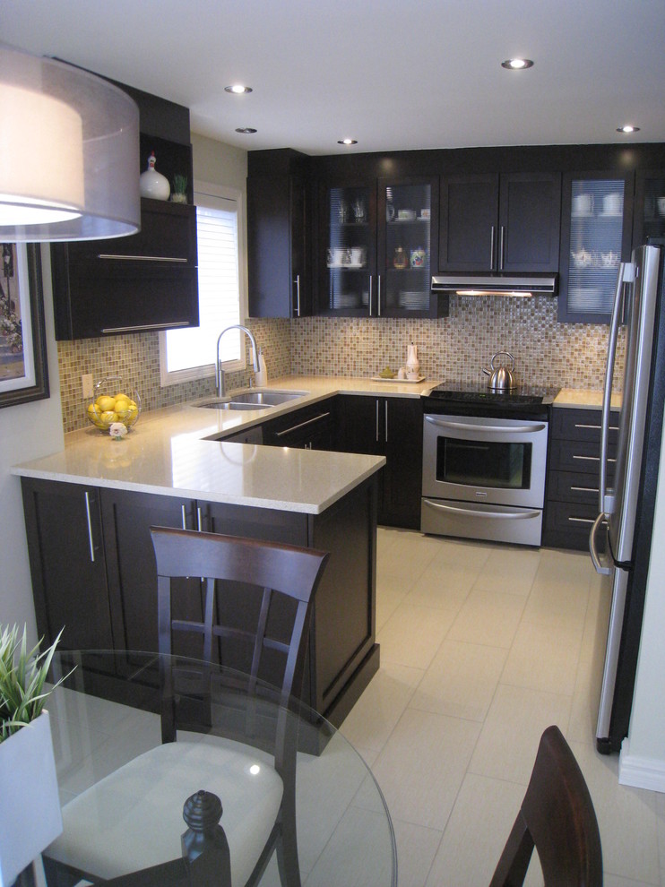 Trendy u-shaped eat-in kitchen photo in Montreal with a double-bowl sink, shaker cabinets, dark wood cabinets, solid surface countertops, multicolored backsplash and stainless steel appliances