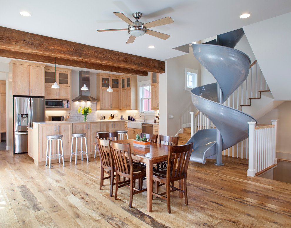 Eat-in kitchen - transitional medium tone wood floor eat-in kitchen idea in Denver with a farmhouse sink, shaker cabinets, light wood cabinets, solid surface countertops, white backsplash, subway tile backsplash, stainless steel appliances and an island