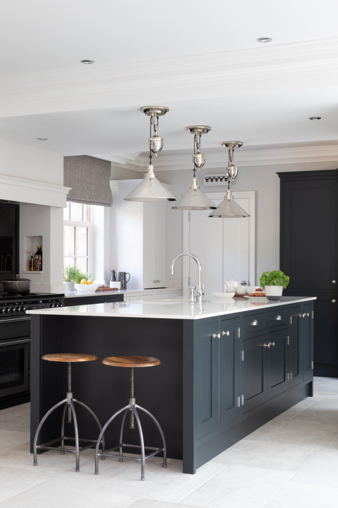 This is an example of a large classic u-shaped kitchen in Other with a submerged sink, shaker cabinets, an island, grey floors and white worktops.