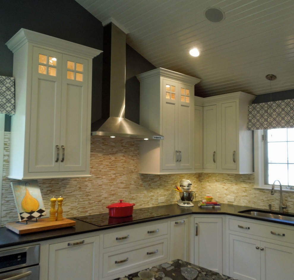 Elegant u-shaped eat-in kitchen photo in Boston with an undermount sink, recessed-panel cabinets, white cabinets, granite countertops, multicolored backsplash and stainless steel appliances