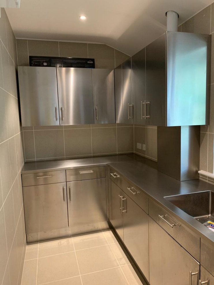 Design ideas for an industrial galley kitchen pantry in Berkshire with an integrated sink, stainless steel cabinets and stainless steel worktops.
