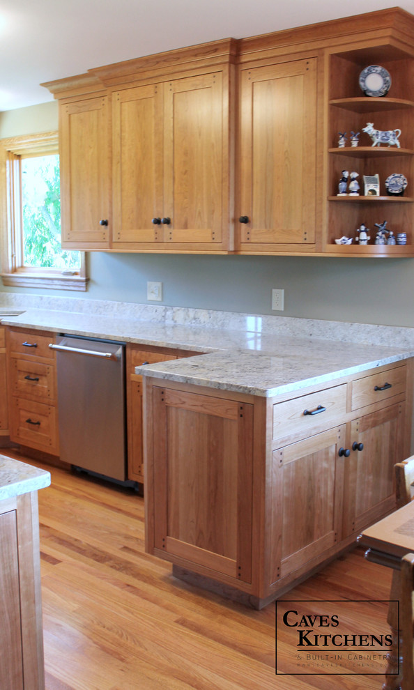 Inspiration for a small craftsman u-shaped medium tone wood floor eat-in kitchen remodel in New York with an undermount sink, recessed-panel cabinets, medium tone wood cabinets, granite countertops, stainless steel appliances, multicolored backsplash, stone slab backsplash and a peninsula