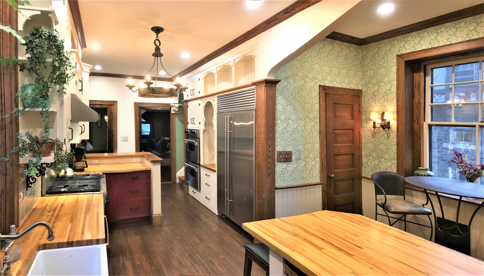 Large ornate l-shaped medium tone wood floor and brown floor open concept kitchen photo in Philadelphia with a farmhouse sink, beaded inset cabinets, white cabinets, wood countertops, green backsplash, porcelain backsplash, stainless steel appliances, an island and brown countertops