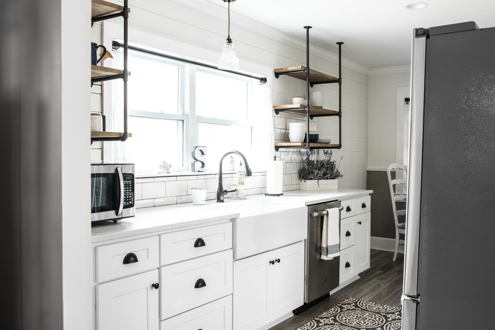 Small farmhouse galley kitchen/diner in Charlotte with shaker cabinets, white cabinets, engineered stone countertops, white splashback, ceramic splashback, no island and white worktops.