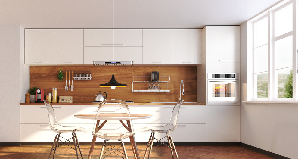 Small modern single-wall kitchen/diner in Other with a double-bowl sink, white cabinets, wood worktops and light hardwood flooring.