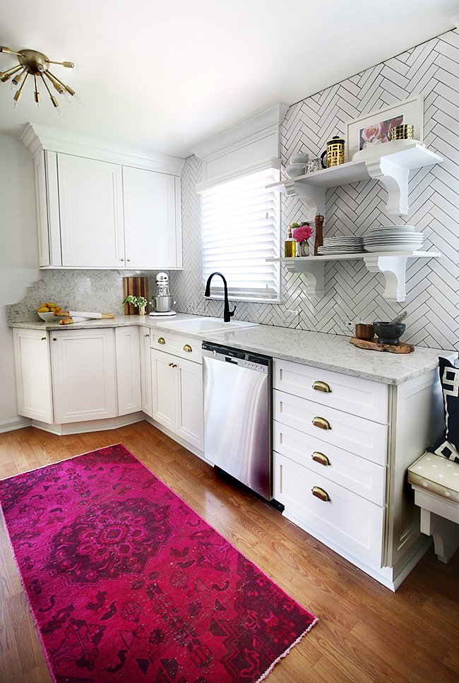 Example of a small classic galley light wood floor eat-in kitchen design in New York with a drop-in sink, recessed-panel cabinets, white cabinets, quartz countertops, white backsplash, subway tile backsplash, stainless steel appliances and no island