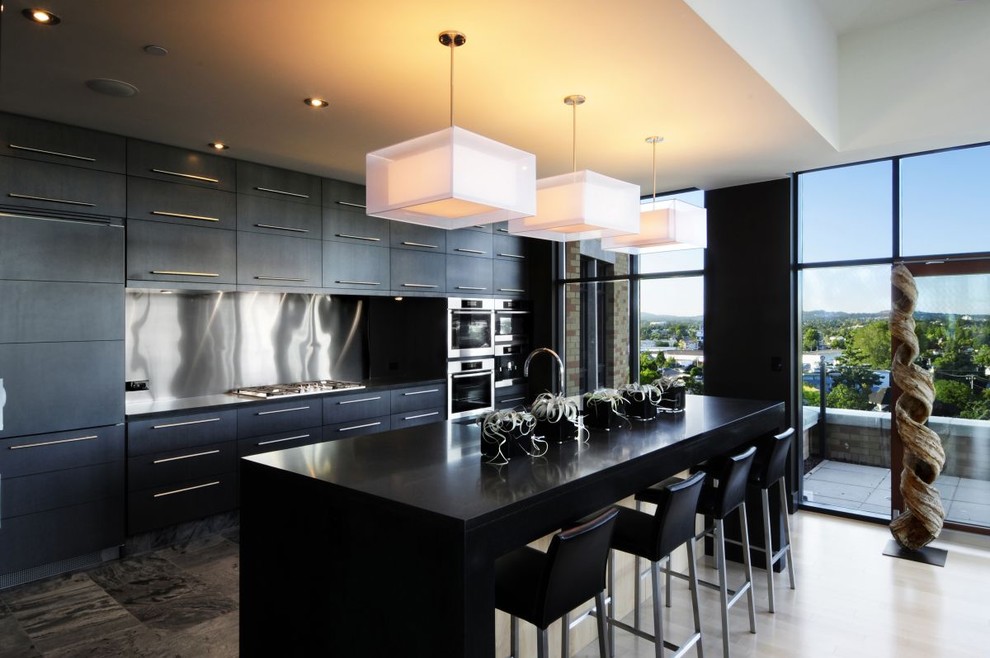 Trendy kitchen photo with black cabinets, metallic backsplash and stainless steel appliances