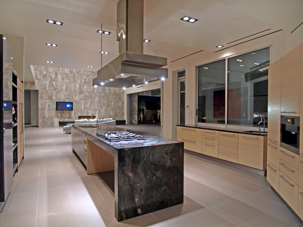 Inspiration for a large contemporary u-shaped porcelain tile and gray floor open concept kitchen remodel in Las Vegas with a double-bowl sink, flat-panel cabinets, light wood cabinets, granite countertops, paneled appliances and an island
