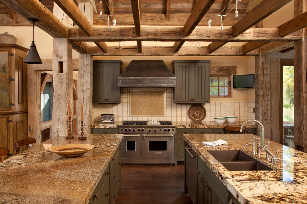 Cette photo montre une cuisine montagne avec un électroménager en acier inoxydable, un évier 2 bacs, des portes de placard grises et une crédence beige.