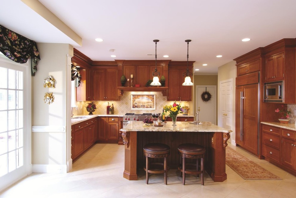 Example of a classic kitchen design in DC Metro with paneled appliances and limestone backsplash