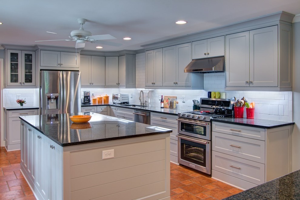 Example of a large eclectic l-shaped terra-cotta tile eat-in kitchen design in Atlanta with a double-bowl sink, shaker cabinets, gray cabinets, granite countertops, white backsplash, ceramic backsplash, colored appliances and an island