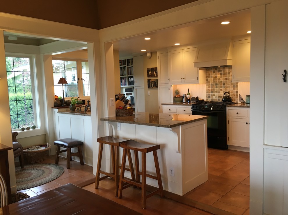 Large country u-shaped ceramic tile enclosed kitchen photo in Seattle with a farmhouse sink, shaker cabinets, white cabinets, granite countertops, multicolored backsplash, ceramic backsplash, black appliances and no island