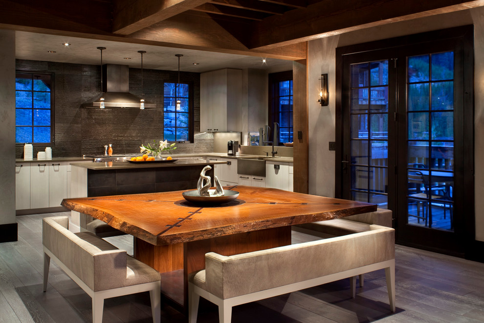 Kitchen/dining room combo - rustic dark wood floor kitchen/dining room combo idea in Other with beige walls