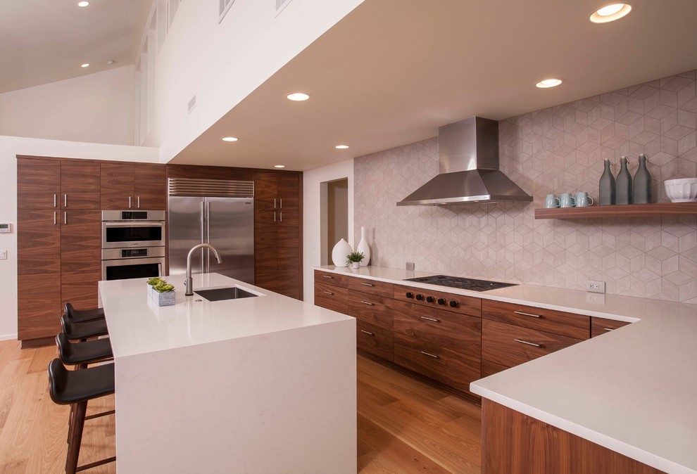 Photo of a contemporary kitchen in Seattle with flat-panel cabinets and an island.