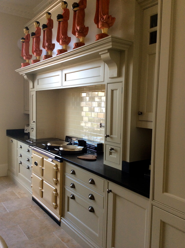 This is an example of a traditional kitchen in Edinburgh with granite worktops, beige splashback and metro tiled splashback.
