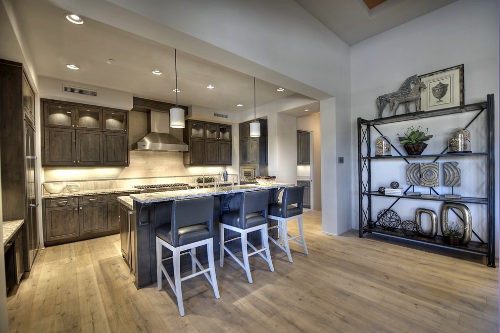 Inspiration for a large transitional l-shaped light wood floor open concept kitchen remodel in Phoenix with a double-bowl sink, gray cabinets and stainless steel appliances