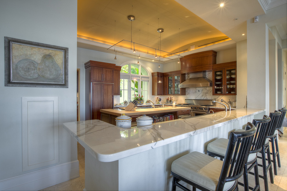 Kitchen - contemporary kitchen idea in Miami with glass-front cabinets, medium tone wood cabinets, white backsplash, stone slab backsplash and paneled appliances